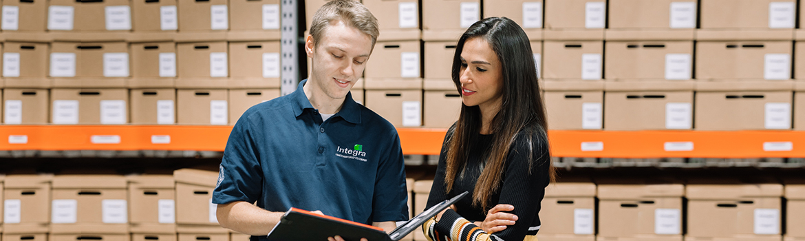 A woman reviews document storage and shredding options with an Integra employee.