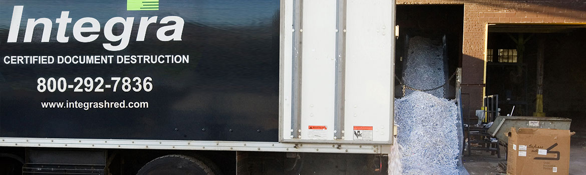 An Integra truck empties shredded paper at secured facility.
